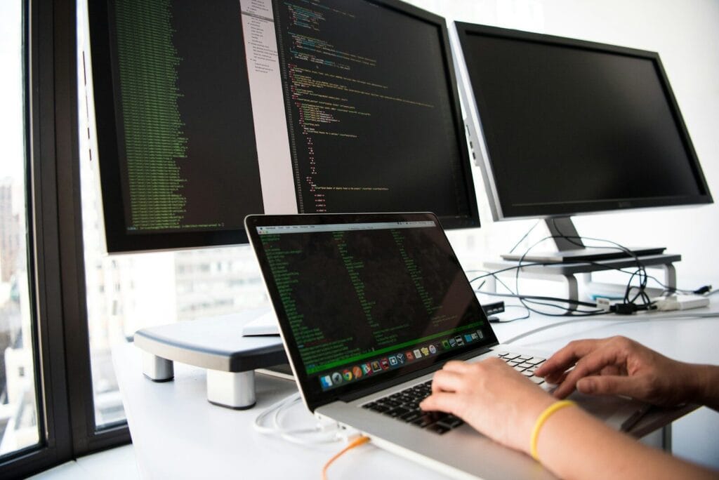 shallow focus photo of person coding on MacBook